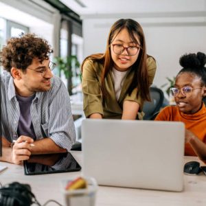 Three young colleagues discussing work at modern office
